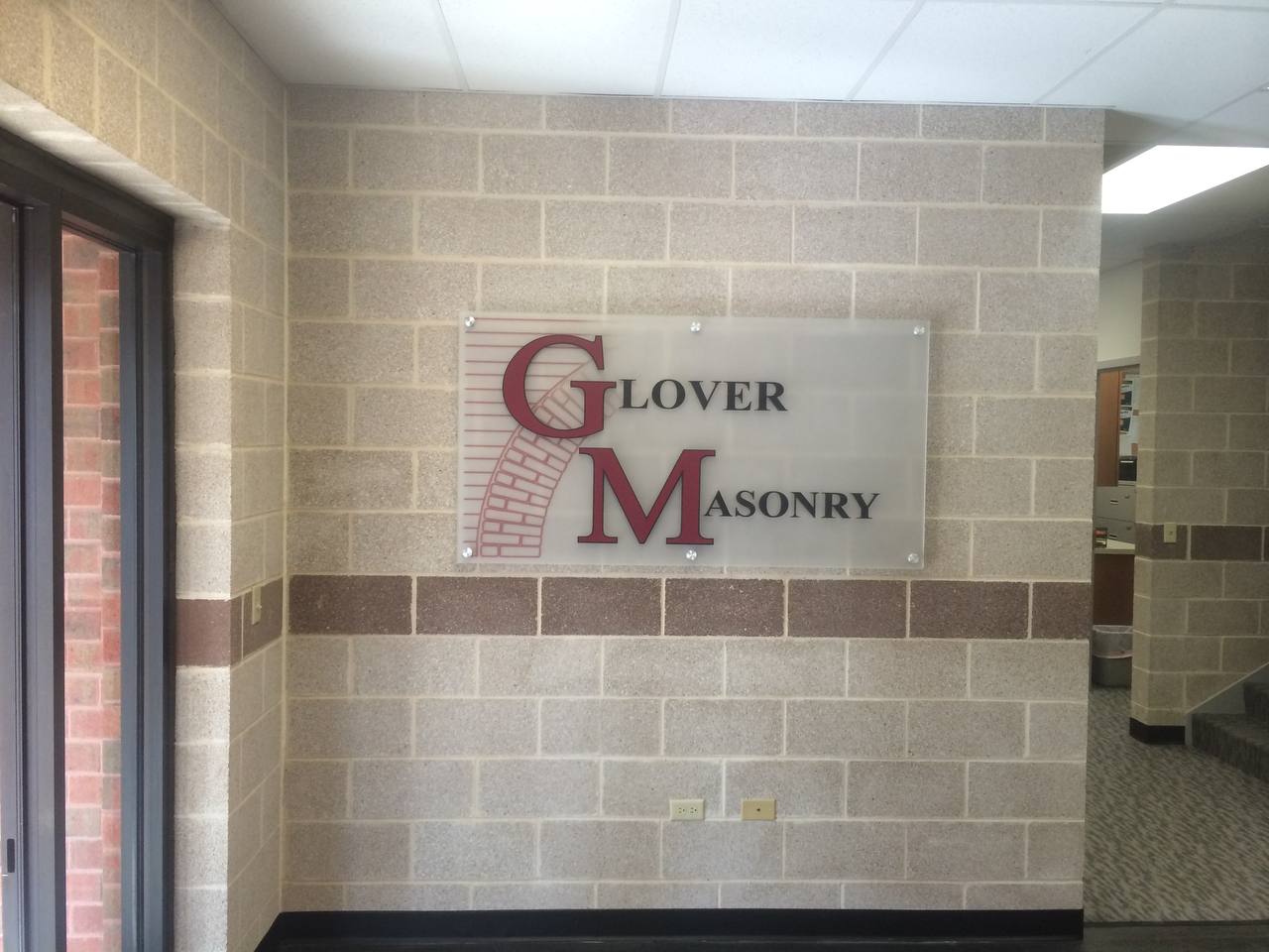 Glover Masonry lobby sign Denver — clean layout and precision installation